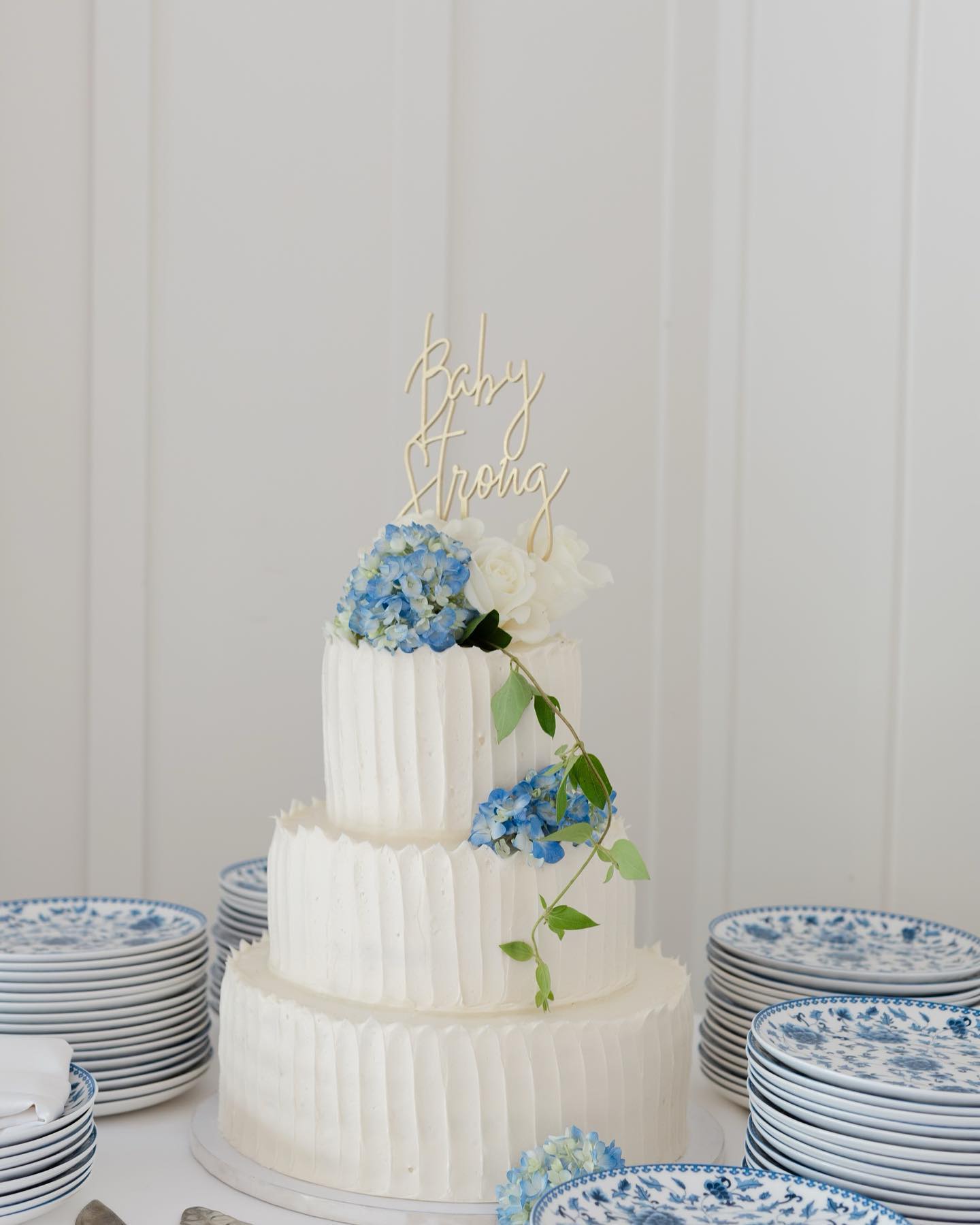 @ladylordphoto photo of a three tier cake with topper that says Baby Strong (topper not from SusieCakes)