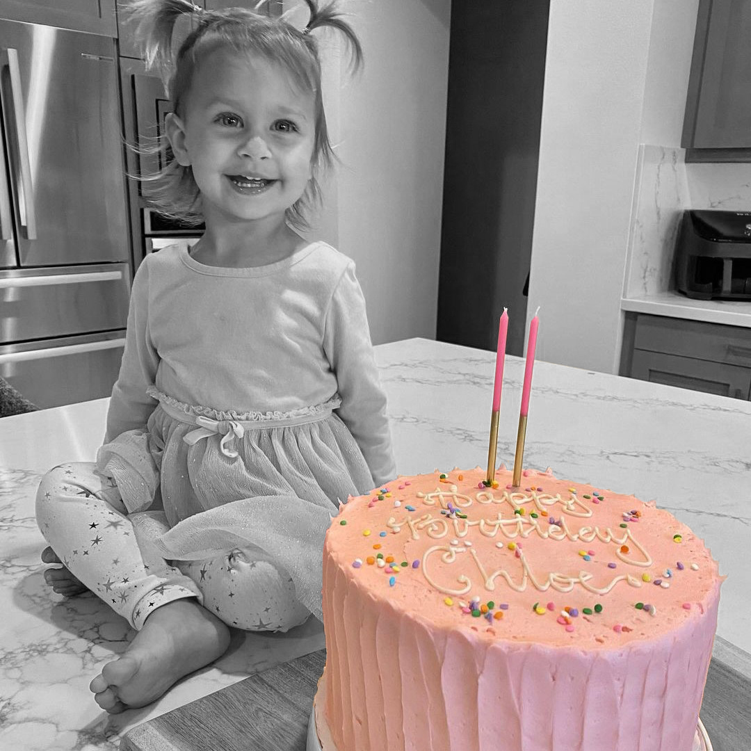 Little girl with SusiePink Celebration birthday cake 