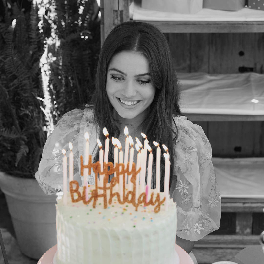 Person celebrating birthday with Celebration Cake