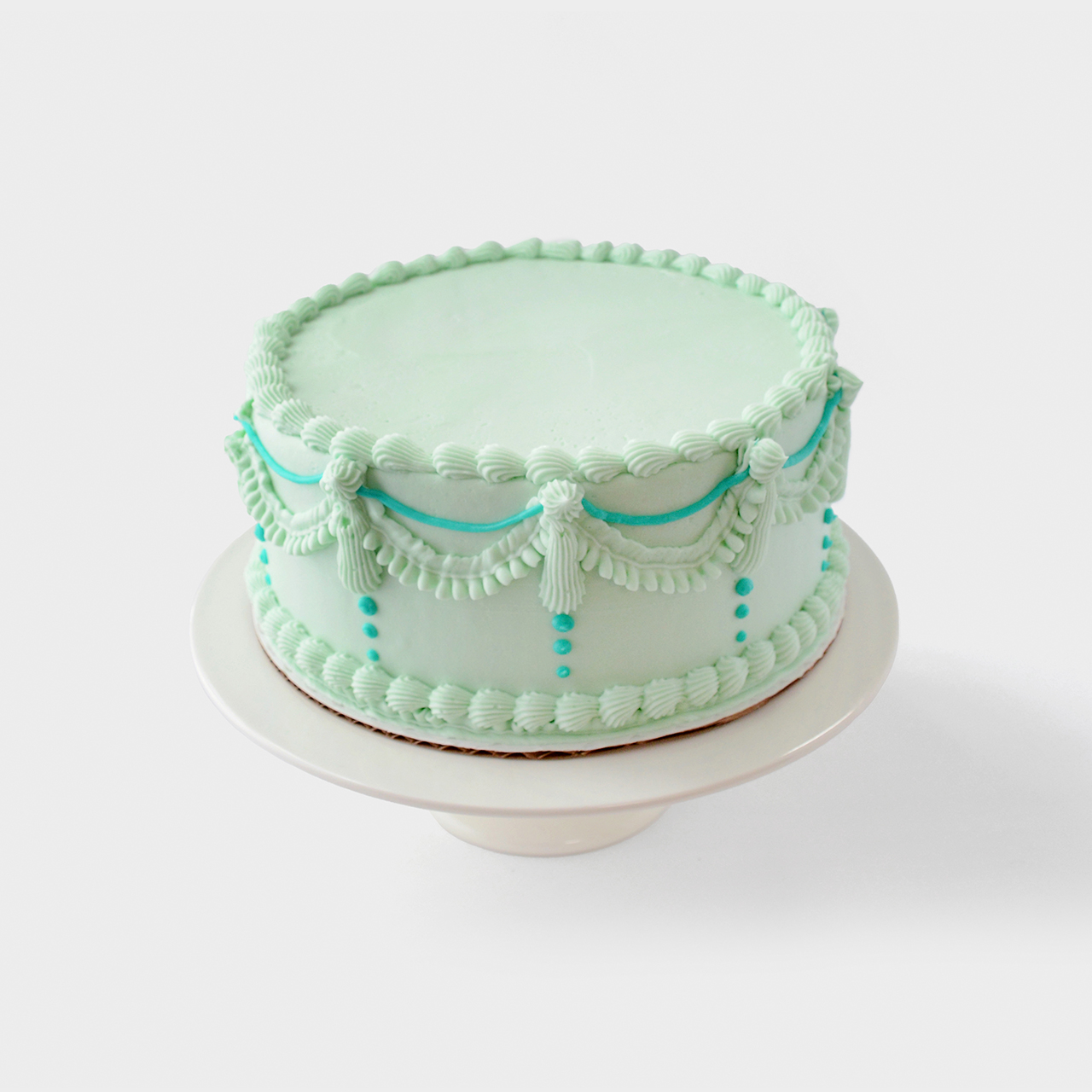 Vintage cake design with light blue buttercream and blue accents 