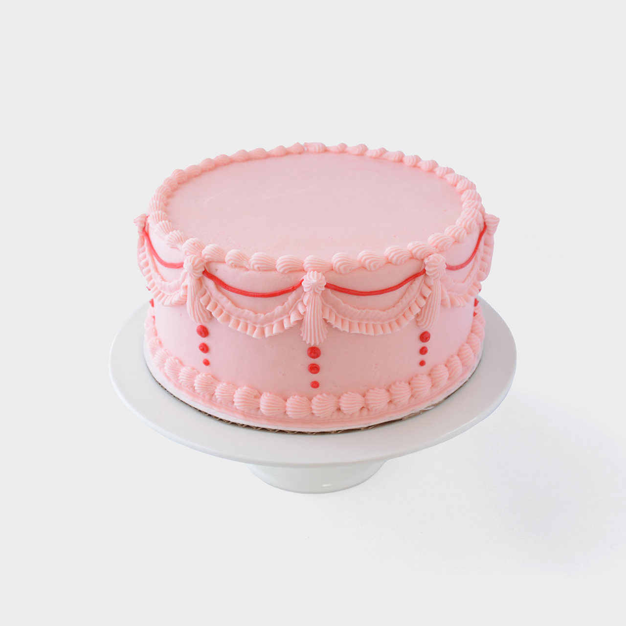 Vintage cake design with pink buttercream and red accents