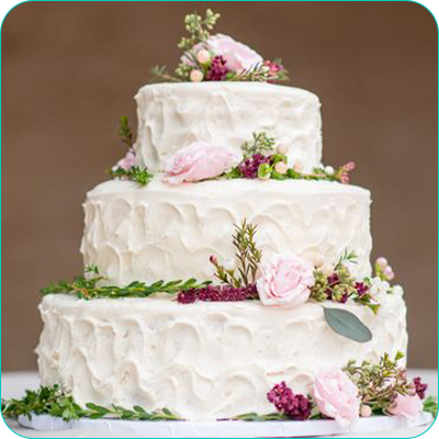 Three tier white wedding cake with flowers